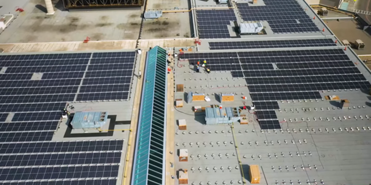 Workers installing solar panels on the CF Chinook Centre